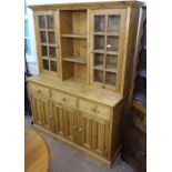 A polished pine 2-section kitchen dresser, fitted with glazed cupboards, W155cm, H189cm