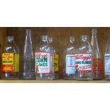 A shelf of 1980s advertising milk bottles, and dairy bottle