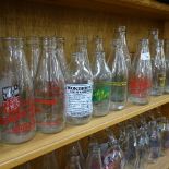 A shelf of 1980s advertising milk bottles, and various dairy bottles