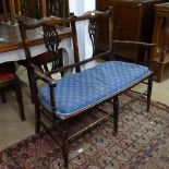 An Edwardian mahogany settee with pierced flat backs