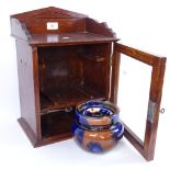 A table-top oak smoker's cabinet, with glazed tobacco jar, cabinet height 38cm