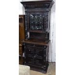 A 19th century Continental 2-section cabinet, having coloured leadlight glazed door, above a