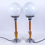 WITHDRAWN: Pair of retro style chrome-mounted table lamps, with globular glass shades, 43cm