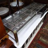 A rectangular glass-top and steel-framed coffee table, with an inset Victorian pierced cast-iron