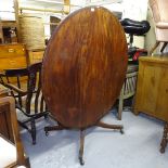 A Regency mahogany and ebony-strung circular tilt-top breakfast table, on reeded sabre leg base,