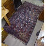 A red ground Afghan design rug with symmetrical pattern, 190cm x 110cm