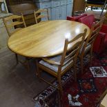 An Ercol "Southwold" honey elm oval dining table, L165cm, together with a set of 4 Ercol "Penn"