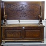 A carved and panelled oak monk's bench, W105cm