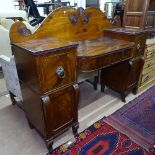 A Regency mahogany bow-front pedestal sideboard, with raised shaped back, fitted drawers and