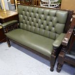 An upholstered and stained wood-framed pub settle