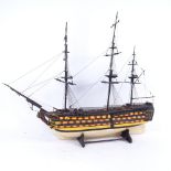 A handmade model of a 19th century first rate ship of the line, on stand, length 65cm, height 55cm