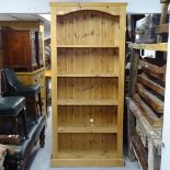 A tall solid pine open bookcase, H198cm