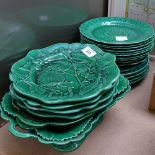 A large quantity of Wedgwood Majolica green glaze leaf and flower plates etc