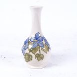 A small mid-century Moorcroft Hibiscus pattern narrow-neck vase, height 16cm