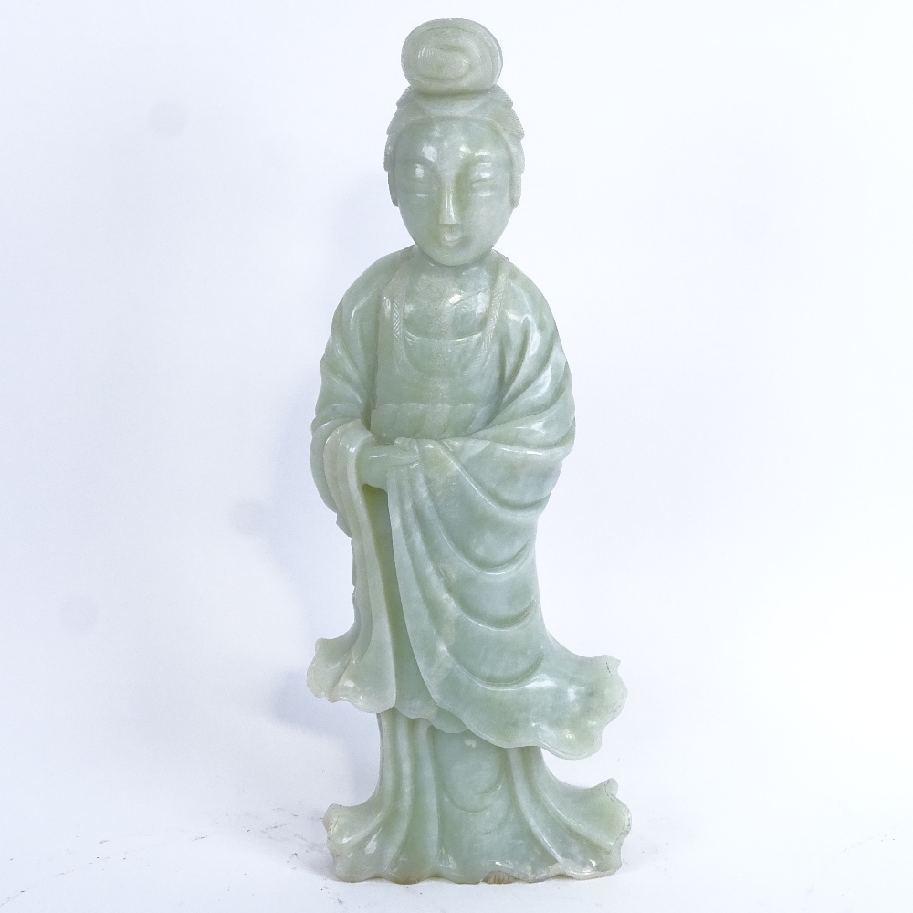 A large Chinese carved and polished jadeite figure, height 36cm