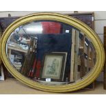 A large gilt-gesso framed oval bevel-edge wall mirror, 60cm x 86cm