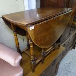 An oak oval gateleg table, on baluster legs, W90cm