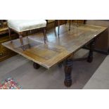 A large oak draw leaf dining table, on cross stretchers and baluster turned legs, L120cm extending