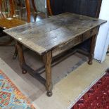 An Antique oak plank-top table with frieze drawer, raised on chamfered legs and H-shaped