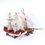 A group of 2 handmade model ships on stands, length 49cm, height 46cm