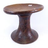 An African Tribal carved hardwood stool, seat diameter 36cm, height 32cm