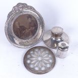 A silver Capstan inkwell, an embossed silver circular photo frame, a silver-topped hair tidy, and