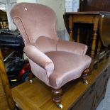 A Victorian upholstered armchair, on turned mahogany legs