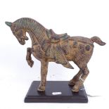 An Oriental patinated iron Tang style horse on wooden plinth, height 22.5cm