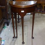 A mahogany demilune double fold over table occasional table, on tapered legs and spade feet, in