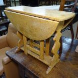 A small light oak drop leaf table, W60cm