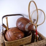 2 wickerwork baskets, containing Vintage badminton rackets, stoolball bats, American football etc