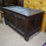 An 18th century joined oak coffer, with chip carved and panelled front, on stile legs, L120cm, H64cm