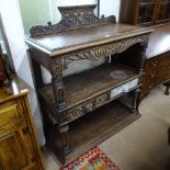 A 1920s carved oak 3-tier buffet, with lion mask frieze drawers, W110cm, H120cm