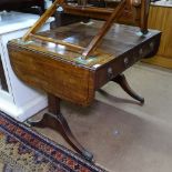 A Regency mahogany sofa table, with 2 frieze drawers having lion mask ring handles, on splayed legs,