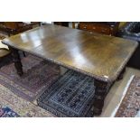 A Victorian oak wind-out dining table, with single spare leaf, acanthus leaf carved edge, and