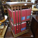 A mahogany revolving bookcase with leather skivered top, and a collection of Great Books on the