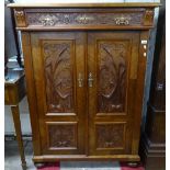An Antique Continental walnut side cabinet, with single frieze drawer above panelled cupboards
