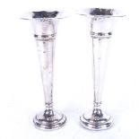 A pair of silver tapered bud vases