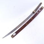A Japanese katana sword, curved steel blade with shagreen grip and brass mounts, with hardwood