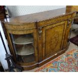 A Victorian figured walnut bow-end credenza, with glazed and panelled cupboard doors, floral