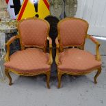 A pair of French carved beech and upholstered open arm bedroom chairs