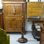 An Edwardian oak turned standard lamp and shade