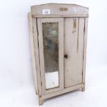 A Vintage painted pine table-top doll's house wardrobe, with mirrored door and internal shelving,