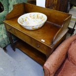 A Victorian mahogany washstand, with raised shaped gallery, short drawers with shelf below, on