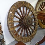 An Antique heavy wooden gun carriage wheel with steel rim and studwork decoration, H113cm