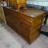 An Ipswich oak design sideboard, with 3 frieze drawers, and fielded cupboards under, on stile