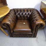 A studded brown leather-upholstered Chesterfield rollover armchair