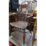 An 18th century elm-seated bow-arm Windsor chair, with crinoline stretcher