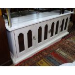 A low painted cabinet, with 4 arch-top mesh panelled doors, on plinth base, L200cm, H75cm, D52cm