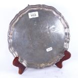 A silver salver with scalloped edge, on cast scrolled feet, Sheffield 1934, 16oz